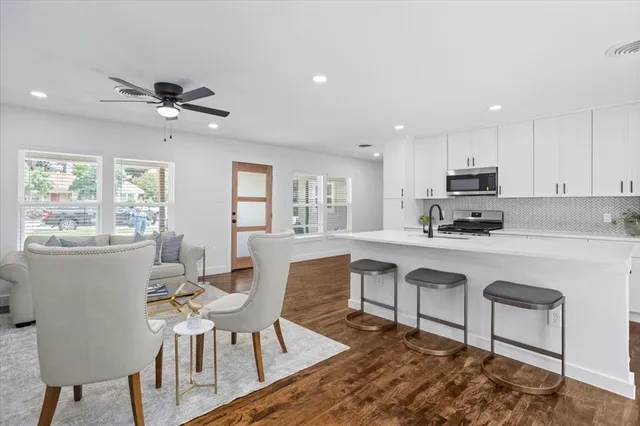 a view of kitchen with cabinets table and chairs