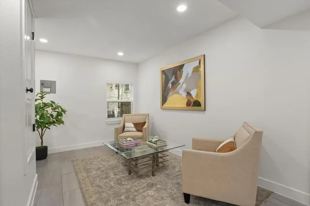 a living room with furniture and a potted plant