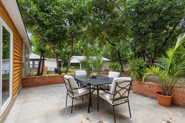 a view of backyard with outdoor seating a patio and plants