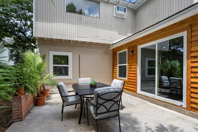 a view of a patio with table and chairs and potted plants