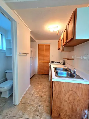 a kitchen with stainless steel appliances granite countertop a sink and a refrigerator
