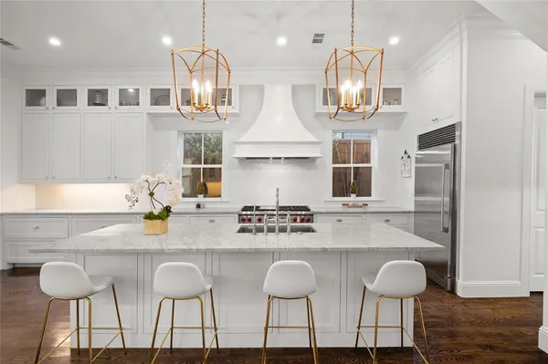 a kitchen with stainless steel appliances granite countertop a kitchen island a stove and a cabinets