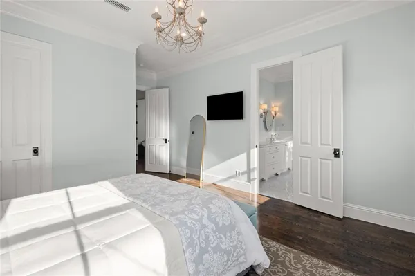 a bedroom with a large bed and a tv