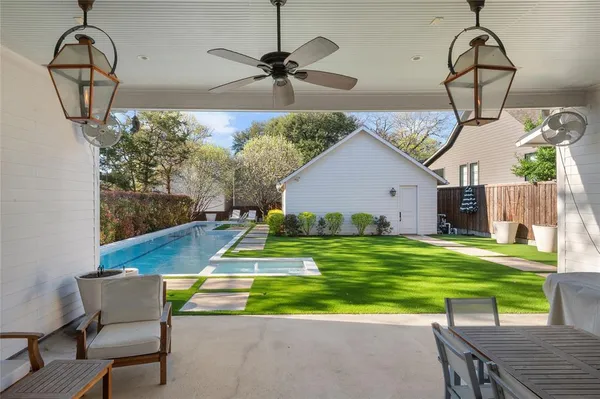 a swimming pool with barbeque oven table and chairs
