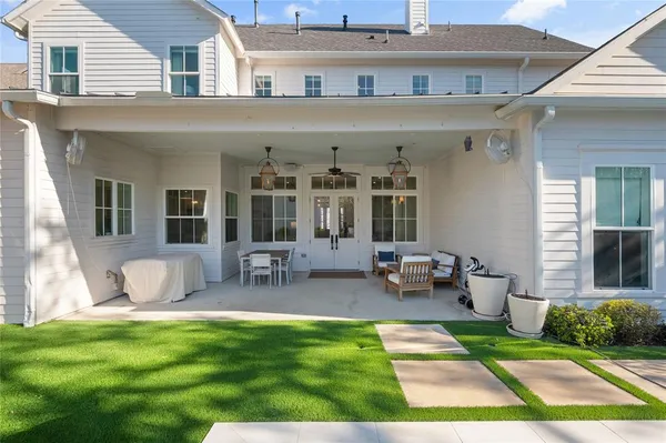 a view of a patio with couches table and chairs with wooden floor and fence