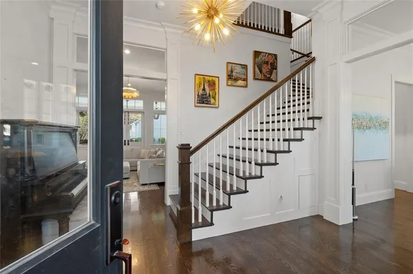a view of entryway and hall with wooden floor