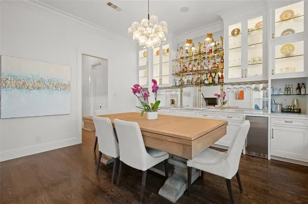 a view of a dining room with furniture and chandelier