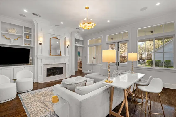 a living room with furniture a fireplace and a flat screen tv