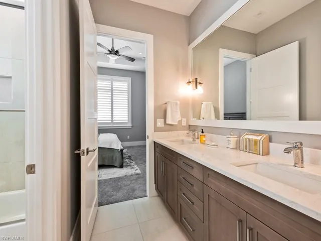a en suite bathroom with double sink and a mirror