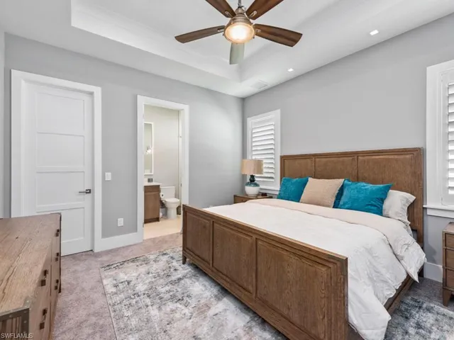 a spacious bedroom with a bed and a chandelier