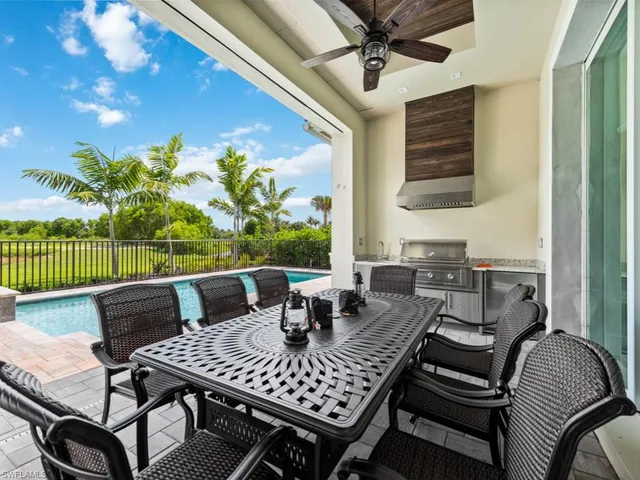 a view of a patio with a dining table and chairs