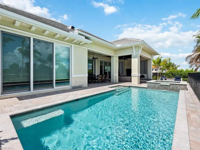 a view of a patio with table and chairs