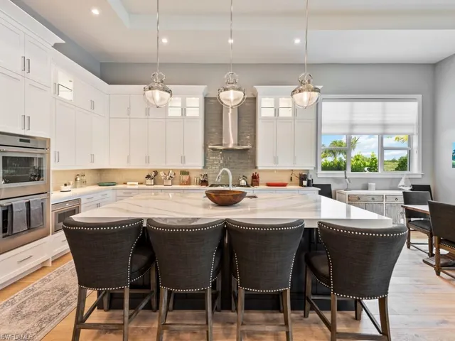 a dining table with chairs and window