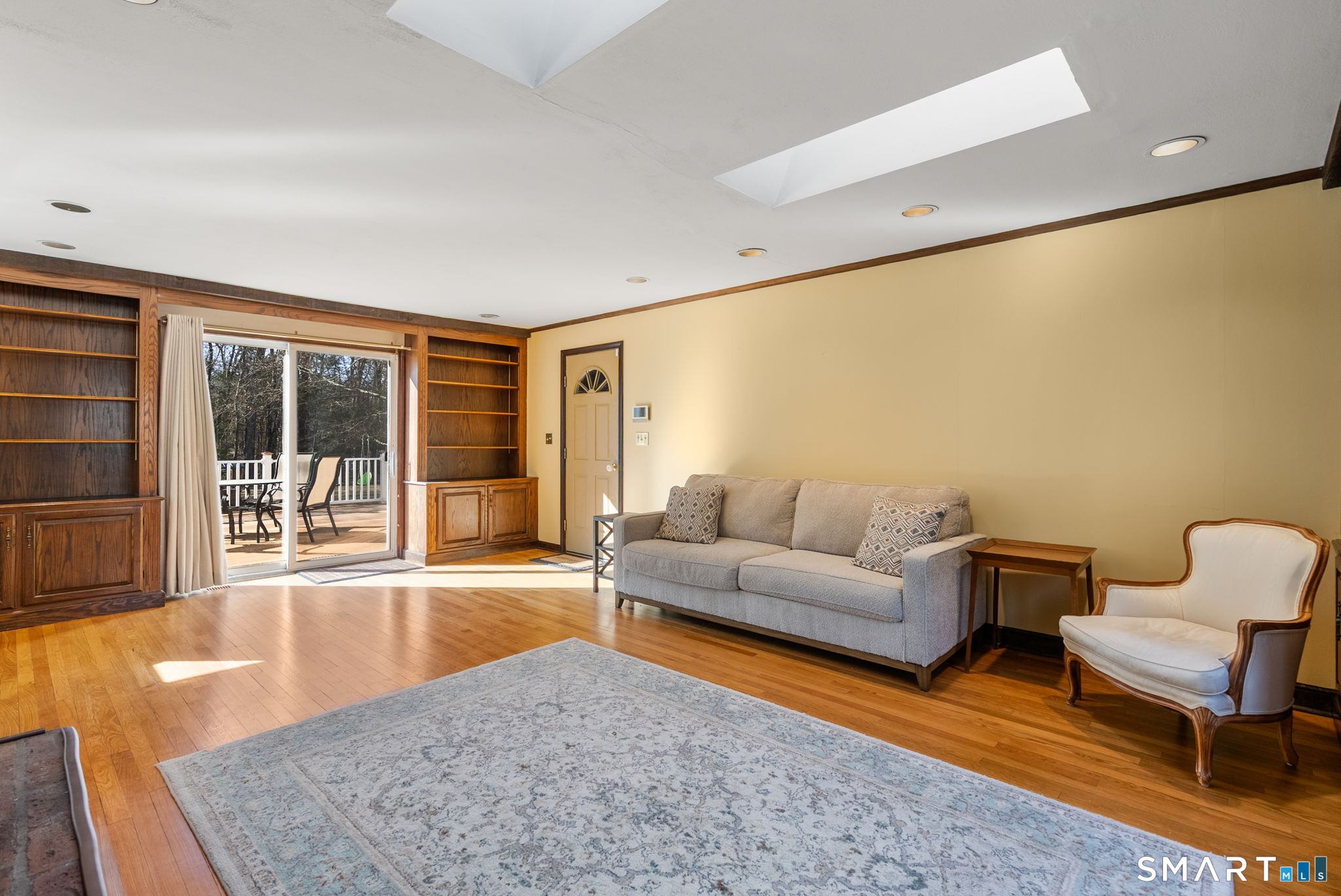 11 Highview Drive Woodbridge, CT 06525 - Photo 7 of 32 Cozy family room with fireplace, open to the kitchen and leading to the deck.