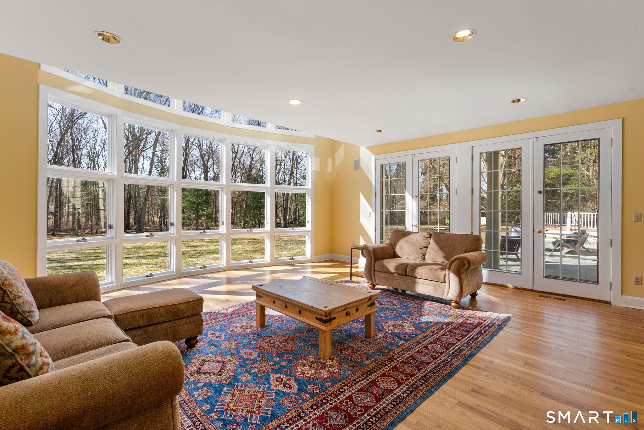 11 Highview Drive Woodbridge, CT 06525 - Photo 10 of 32 Stunning great room with two-story floor-to-ceiling windows and French doors to the bluestone patio.