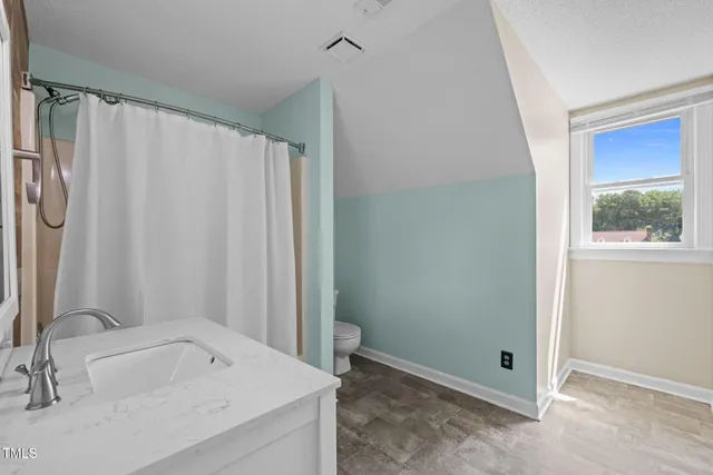 a bathroom with a tub a sink and a large mirror