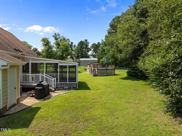 a view of house with backyard space and seating