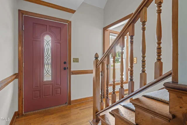 a view of an entryway with wooden floor and stairs