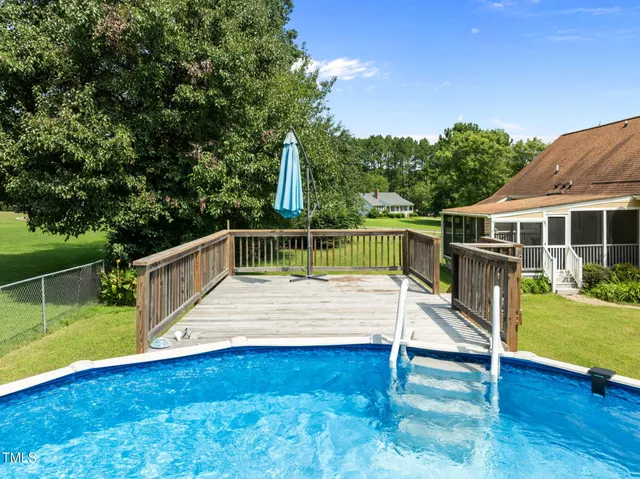 a view of a roof deck with chair and garden