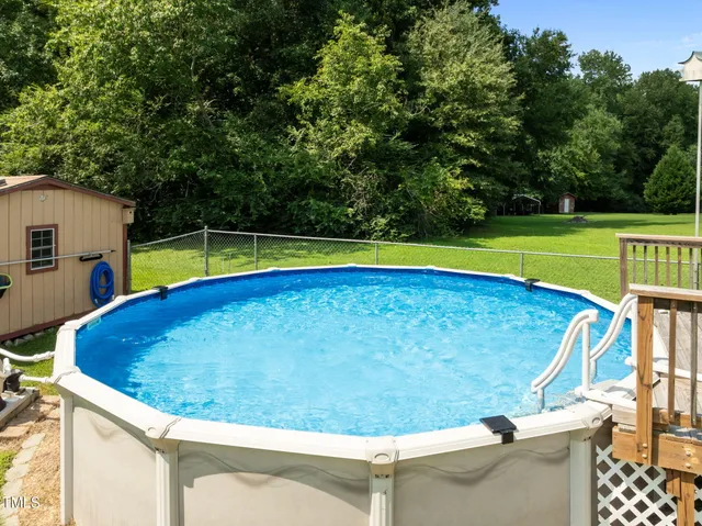 a view of a swimming pool with a yard