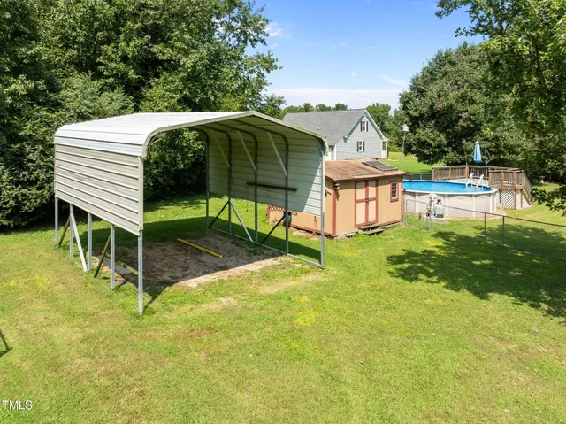 a view of a wooden deck and a yard