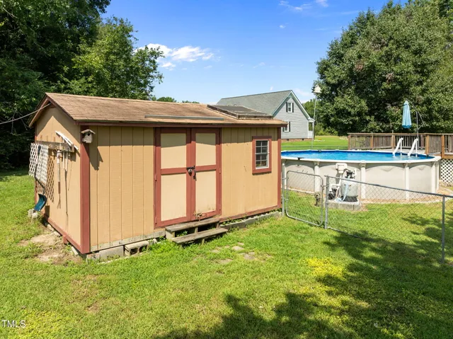 a backyard of a house with table and chairs