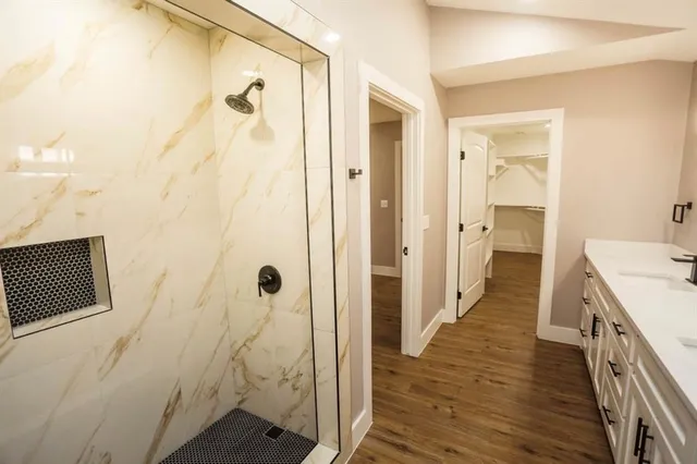 a bathroom with a double vanity sink and a mirror