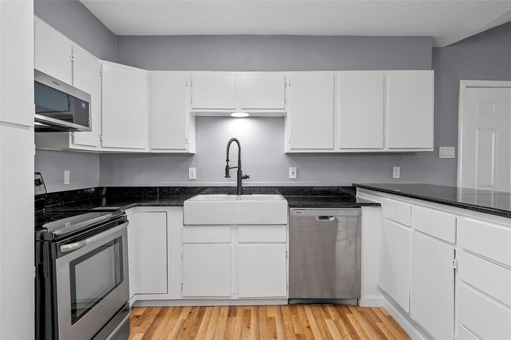 711 Rosedale Drive Hewitt, TX 76643 - Photo 6 of 16 a kitchen with granite countertop white cabinets and stainless steel appliances