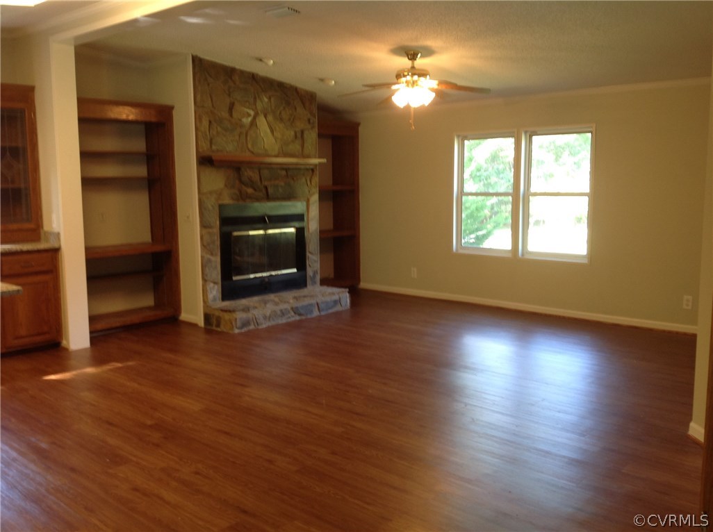 1038 Morning Star Road Appomattox, VA 24522 - Photo 8 of 22 an empty room with wooden floor fireplace and fan