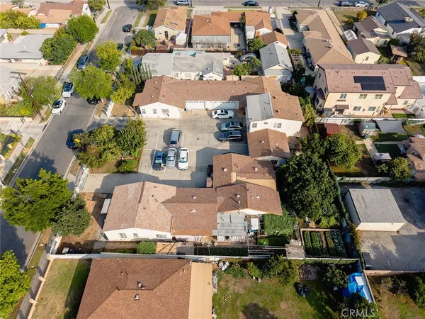 an aerial view of residential houses with outdoor space