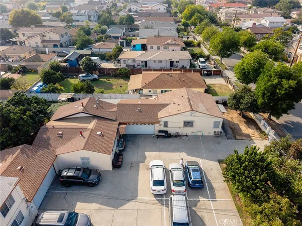 an aerial view of a house with garden space and street view