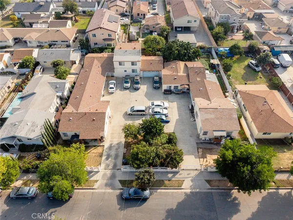 an aerial view of multiple houses with yard