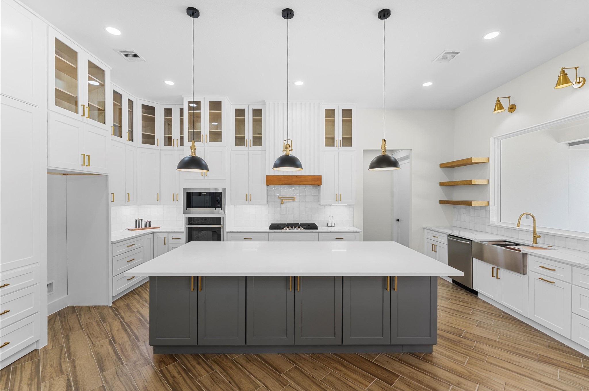 118 Ranger Road Huntsville, TX 77340 - Photo 15 of 49 Chef’s dream kitchen featuring custom cabinetry, oversized island, quartz counters, modern fixtures, and abundant windows that overlook the backyard.