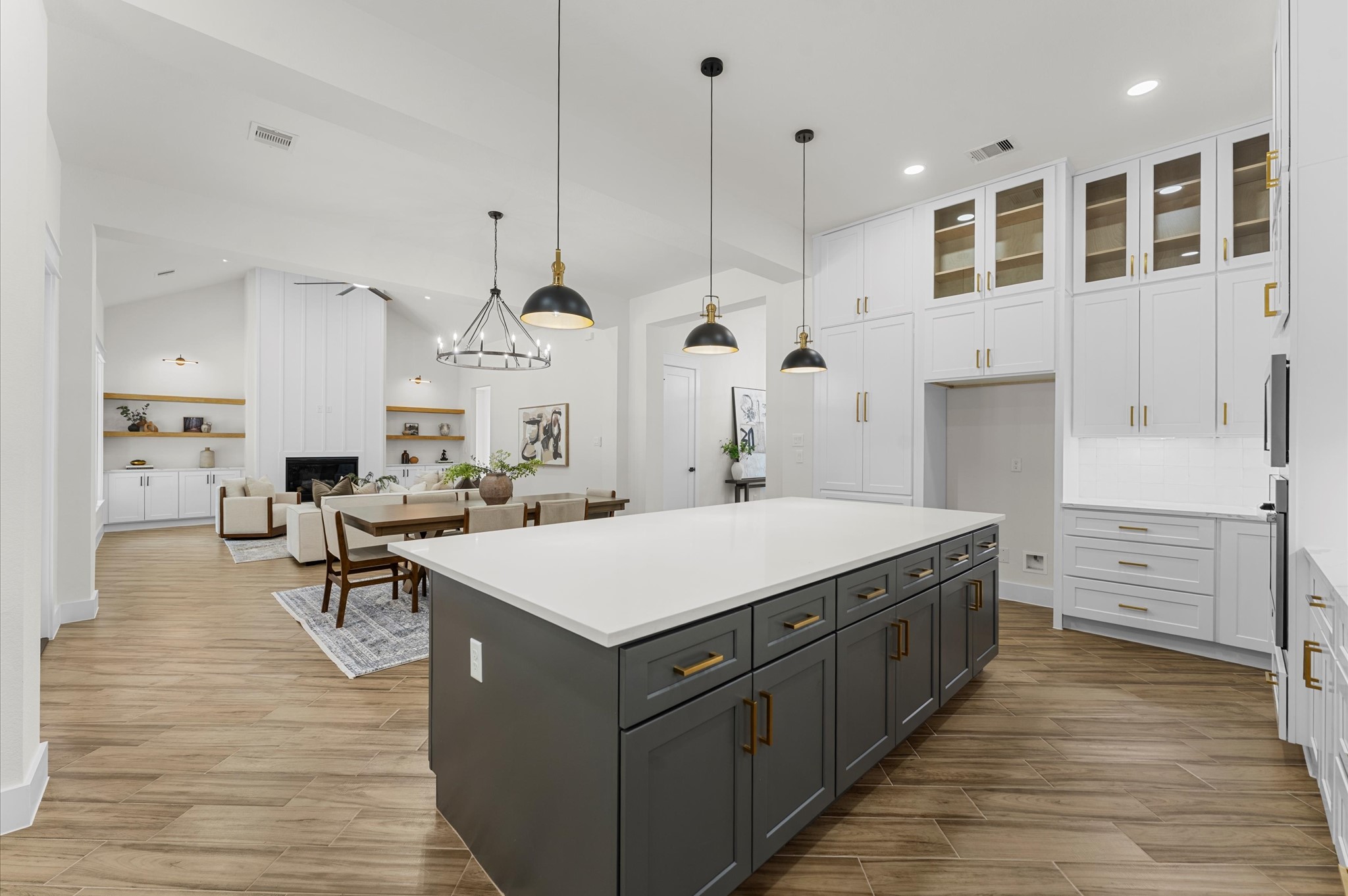118 Ranger Road Huntsville, TX 77340 - Photo 20 of 49 Chef’s dream kitchen featuring custom cabinetry, oversized island, quartz counters, modern fixtures, and abundant windows that overlook the backyard.