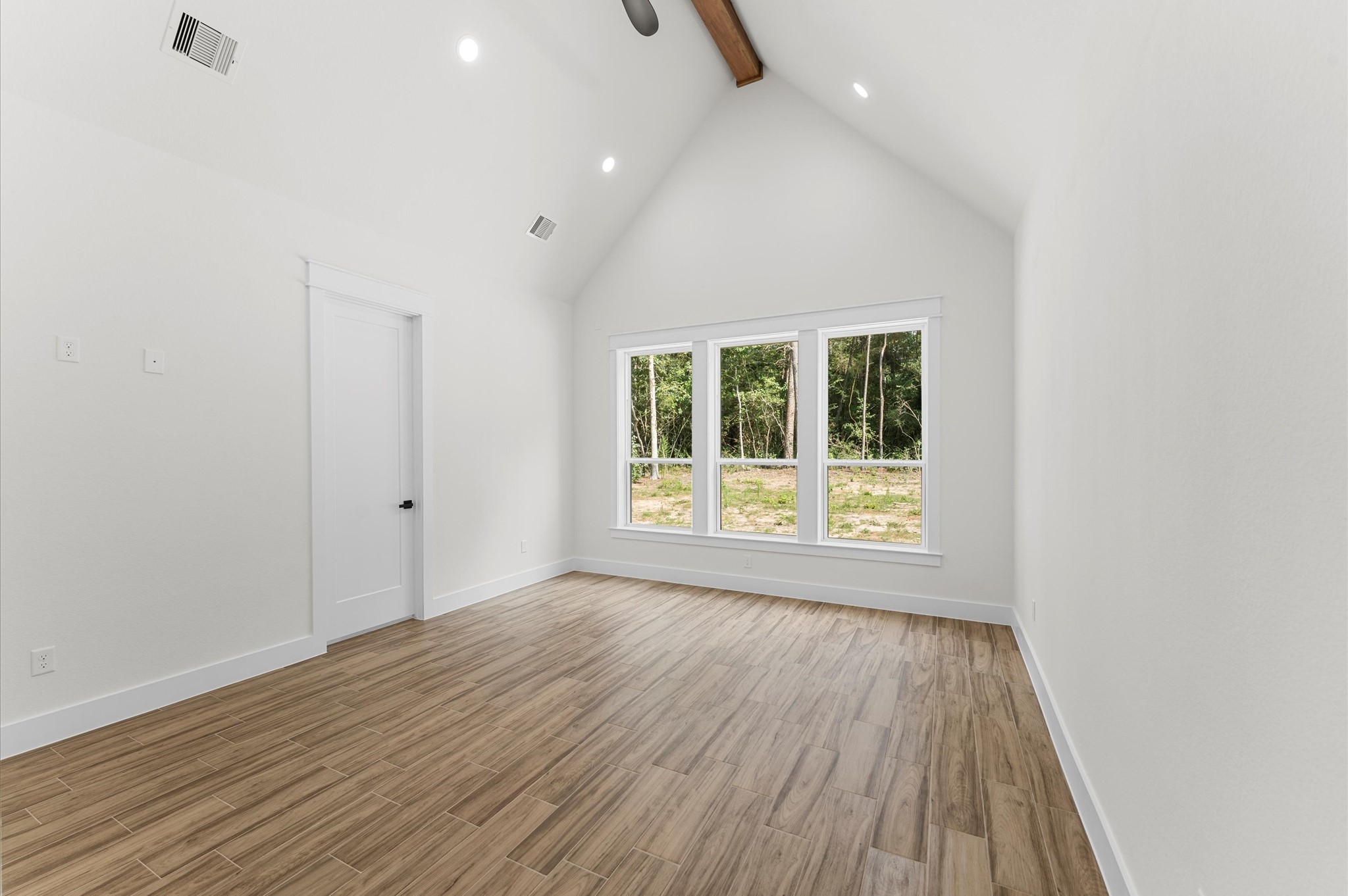 118 Ranger Road Huntsville, TX 77340 - Photo 25 of 49 a view of an empty room with wooden floor and a window