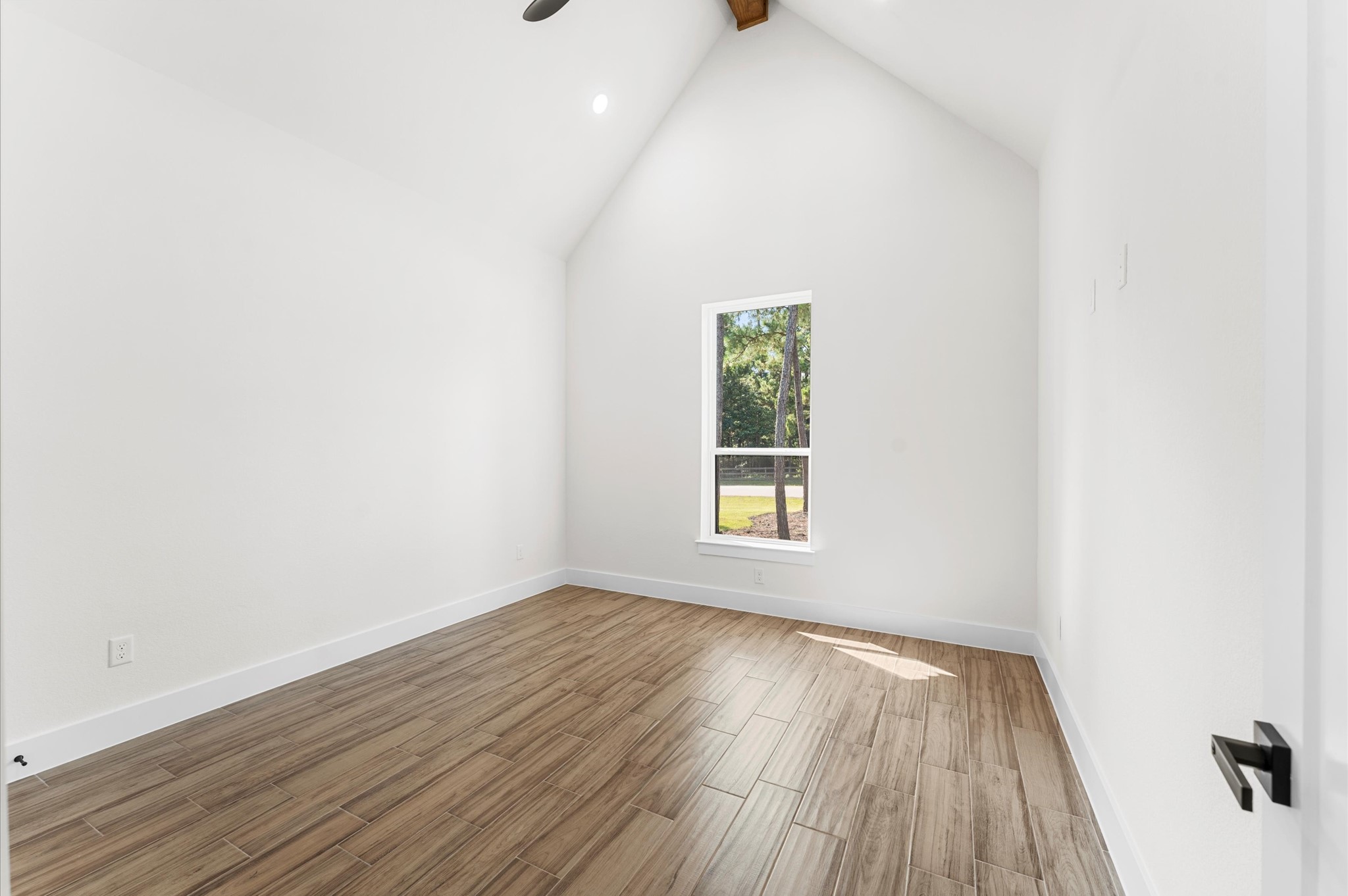 118 Ranger Road Huntsville, TX 77340 - Photo 33 of 49 an empty room with wooden floor and windows