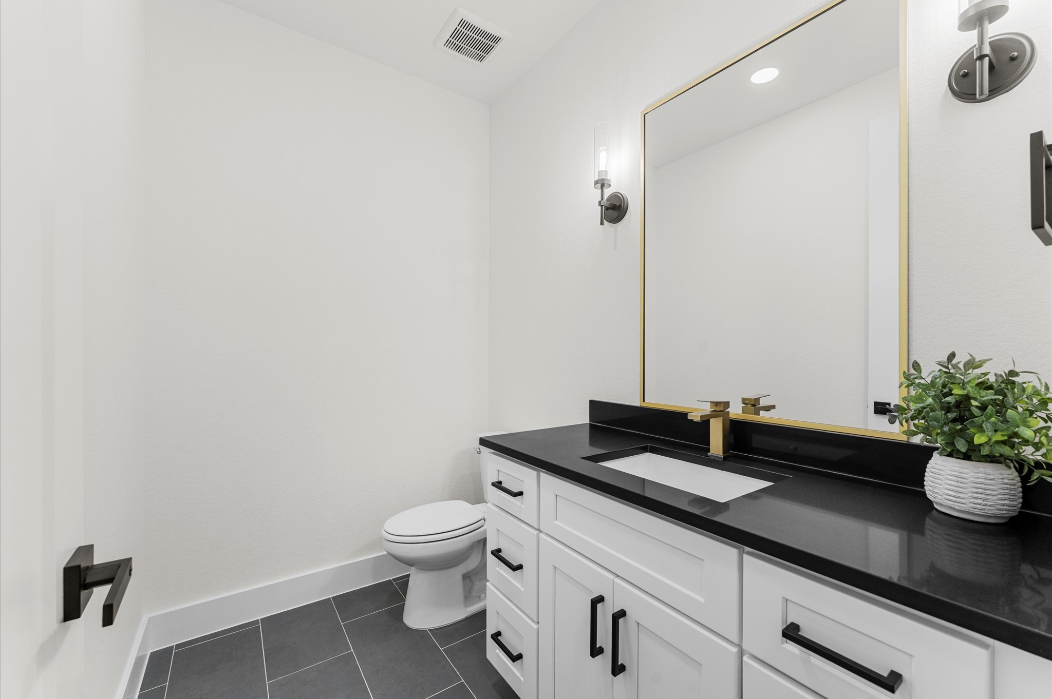 118 Ranger Road Huntsville, TX 77340 - Photo 38 of 49 a bathroom with a granite countertop sink a toilet and a mirror