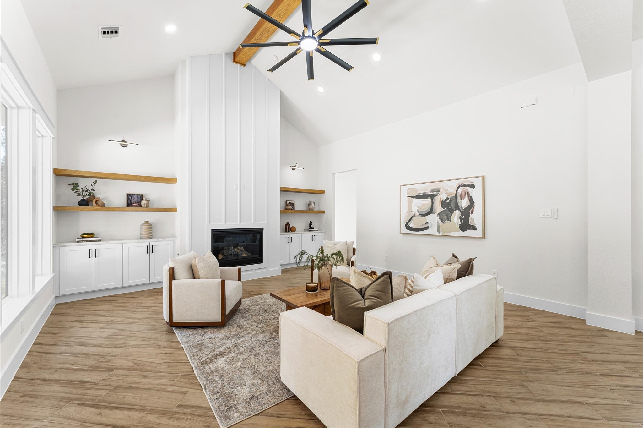 118 Ranger Road Huntsville, TX 77340 - Photo 10 of 49 Grand living area with cathedral ceiling, cozy chimney, large windows for natural light, and open flow to the kitchen and dining—perfect for entertaining.