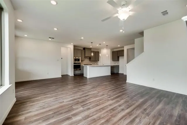 a view of kitchen with cabinets and wooden floor