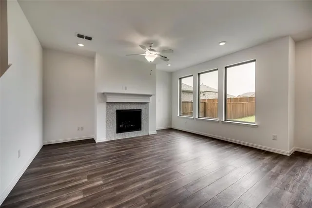 a kitchen with a kitchen island wooden floor appliances and a window
