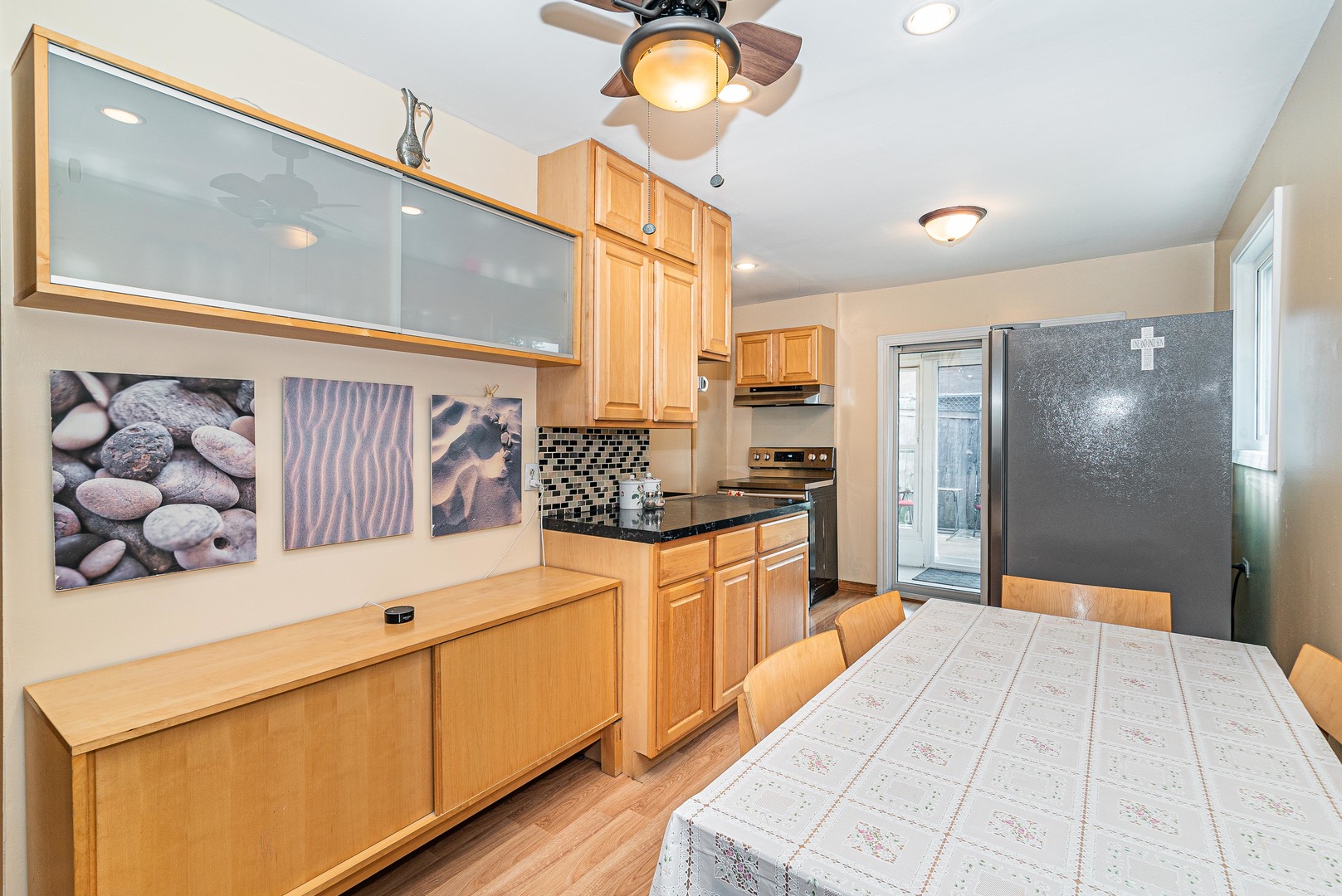 9415 Sumac Road, Unit A Des Plaines, IL 60016 - Photo 4 of 21 a large kitchen with stainless steel appliances kitchen island granite countertop a refrigerator and a stove top oven