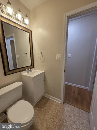 a bathroom with a toilet a sink and a mirror