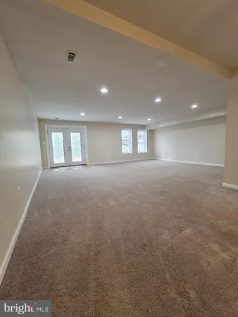 a view of empty room with window and fireplace