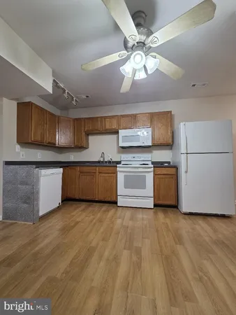 a view of a kitchen with a sink cabinets and stainless steel appliances