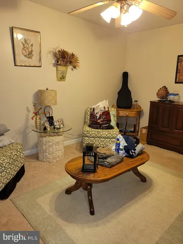 a living room with furniture and a mirror