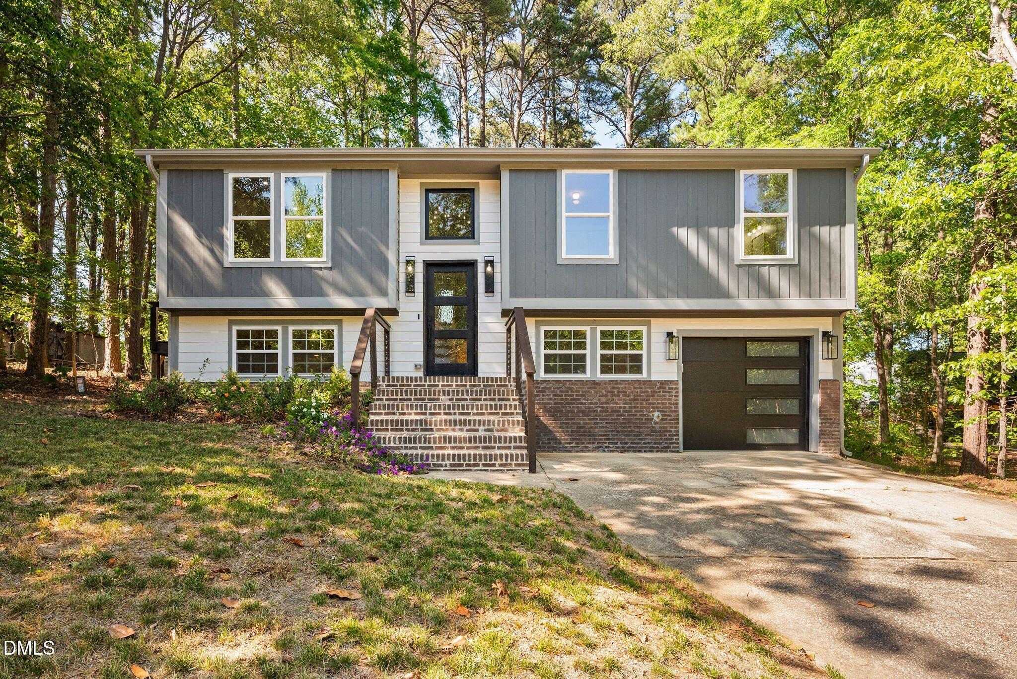 313 Crown Oaks Drive Raleigh, NC 27615 - Photo 2 of 60 a front view of a house with a yard