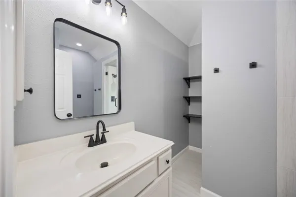 a bathroom with a sink and a mirror