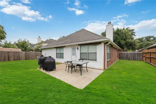 a view of an house with backyard space and garden