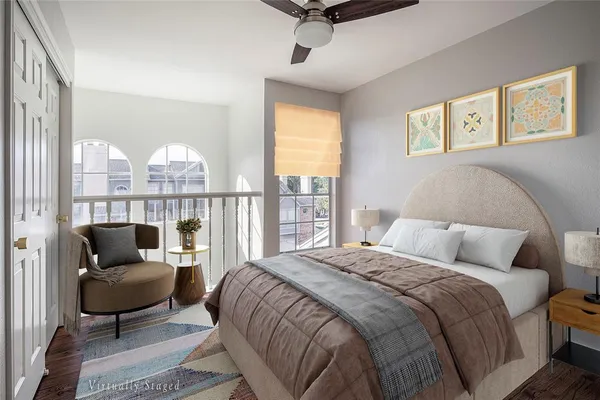 a bedroom with a bed a couch and a window