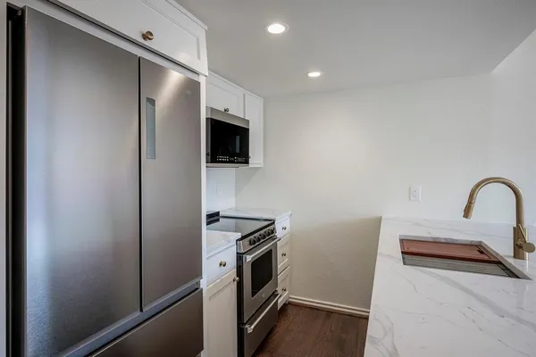 a kitchen with a refrigerator and a sink